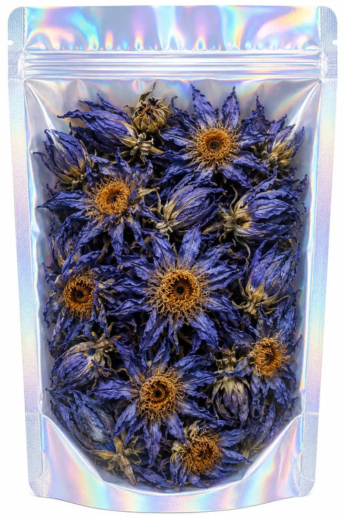 A clear, resealable stand-up pouch with an iridescent holographic finish, filled with dried blue-lotus flowers with orange-brown centers, is shown against a plain white background.
