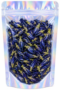 A clear holographic stand-up pouch filled with dried blue lotus flowers, shown against a plain white background.