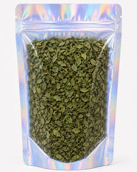 A clear, resealable stand-up pouch filled with dried green lemon balm leaves
